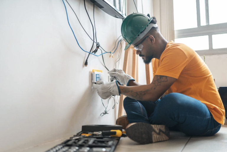Independent contractor fixing a wire in an office